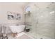 Bright main bathroom with a soaking tub, glass shower, and window at 6958 W Morning Dove Dr, Glendale, AZ 85308