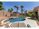 Resort-style pool with palm trees, rock features, and stylish lounge chairs at 6958 W Morning Dove Dr, Glendale, AZ 85308