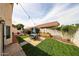 The backyard features manicured grass, a colorful rug and patio furniture under string lights at 7110 N 28Th Dr, Phoenix, AZ 85051