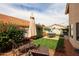 The backyard offers lounge seating, a dining table, lush bushes, and ambient string lights at 7110 N 28Th Dr, Phoenix, AZ 85051