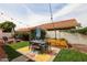 Beautiful backyard with colorful rug under patio furniture, lounge chairs, and string lights at 7110 N 28Th Dr, Phoenix, AZ 85051