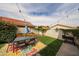 Inviting backyard with a well-manicured lawn, lush garden, and a patio dining set at 7110 N 28Th Dr, Phoenix, AZ 85051