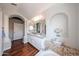 Elegant bathroom boasts dual sinks, jacuzzi tub with mosaic tile accents and an archway detail at 7110 N 28Th Dr, Phoenix, AZ 85051