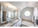 Elegant bathroom features dual sinks, oval windows, and soaking tub with mosaic tile accents at 7110 N 28Th Dr, Phoenix, AZ 85051