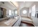 Bright bathroom features a soaking tub and a dual sink vanity with a large mirror at 7110 N 28Th Dr, Phoenix, AZ 85051