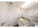 Bright bathroom featuring a large mirror and neutral countertops, paired with white cabinetry at 7110 N 28Th Dr, Phoenix, AZ 85051