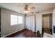Comfortable bedroom with hardwood floors, ceiling fan, and a bright window at 7110 N 28Th Dr, Phoenix, AZ 85051