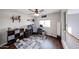 Bright bedroom with wood floors, a ceiling fan, and neutral decor with a gaming setup at 7110 N 28Th Dr, Phoenix, AZ 85051