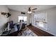 Bedroom featuring hardwood floors, a desk, and a window, with a partial view of the upper level at 7110 N 28Th Dr, Phoenix, AZ 85051