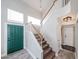 Inviting entryway with a staircase, dark green door, and modern light fixtures at 7110 N 28Th Dr, Phoenix, AZ 85051