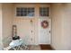 Welcoming entryway featuring a decorative wreath, seating area, and 'Hello' door mat at 7110 N 28Th Dr, Phoenix, AZ 85051