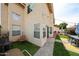 Exterior backyard view of a tan two-story home featuring outdoor seating and mature vegetation at 7110 N 28Th Dr, Phoenix, AZ 85051