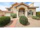 Charming two-story home featuring a tile roof, arched entry, and manicured front yard at 7110 N 28Th Dr, Phoenix, AZ 85051