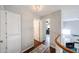 Hallway with wood floors and white doors, leading to other rooms in the house at 7110 N 28Th Dr, Phoenix, AZ 85051