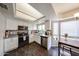 Kitchen featuring stainless steel appliances, white cabinetry, and a window with a view of the backyard at 7110 N 28Th Dr, Phoenix, AZ 85051