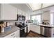 Bright kitchen with stainless steel appliances, white cabinets, and ample countertop space at 7110 N 28Th Dr, Phoenix, AZ 85051
