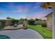Cozy backyard with putting green, stone fireplace, and relaxed seating for enjoying tranquil outdoor moments at 7307 E Black Rock Rd, Scottsdale, AZ 85255