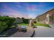 Charming backyard with stone fireplace, putting green, and seating, perfect for enjoying outdoor living at 7307 E Black Rock Rd, Scottsdale, AZ 85255