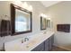 Bathroom featuring dual sinks, dark wood cabinets, and a large mirror at 7307 E Black Rock Rd, Scottsdale, AZ 85255