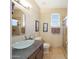A bathroom with a glass bowl sink, granite countertop, and a framed mirror at 7307 E Black Rock Rd, Scottsdale, AZ 85255
