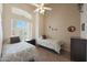 A cozy bedroom with two twin beds and a large window at 7307 E Black Rock Rd, Scottsdale, AZ 85255