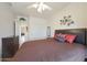 Bedroom with light walls, a ceiling fan, wood-look floors, and a closet at 7307 E Black Rock Rd, Scottsdale, AZ 85255