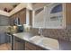 Bright kitchen with stainless steel appliances and a window overlooking the backyard at 7307 E Black Rock Rd, Scottsdale, AZ 85255