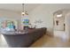 Comfortable living room features a cozy fireplace, ceiling fan, tile flooring, and a plush leather sofa at 7307 E Black Rock Rd, Scottsdale, AZ 85255