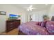 A main bedroom with wood floors, ceiling fan, and television at 7307 E Black Rock Rd, Scottsdale, AZ 85255
