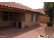 This home has a covered back patio area with a tiled countertop and access to the backyard at 8008 W Ross Ave, Peoria, AZ 85382