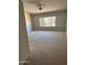 Cozy bedroom with a large window, neutral carpet, and ceiling fan, offering a comfortable and relaxing space at 8008 W Ross Ave, Peoria, AZ 85382