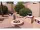 The backyard features a charming fire pit surrounded by seating and complemented by lush greenery at 8008 W Ross Ave, Peoria, AZ 85382