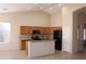 Well-lit kitchen boasts ample cabinet space, granite countertops, modern appliances, and tiled floors at 8008 W Ross Ave, Peoria, AZ 85382