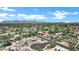 Scenic aerial shot of a home nestled in a neighborhood with stunning mountain views at 8936 N 80Th Pl, Scottsdale, AZ 85258