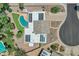 Aerial shot of home featuring a pool, solar panels, desert landscaping, and a tile roof at 8936 N 80Th Pl, Scottsdale, AZ 85258