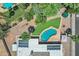 Aerial view of a house with a pool, solar panels, and desert landscaping at 8936 N 80Th Pl, Scottsdale, AZ 85258