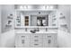 Bathroom with double sinks and large mirror plus additional shelves at 8936 N 80Th Pl, Scottsdale, AZ 85258