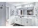 Bathroom with double sinks and large mirror plus toilet and shelving at 8936 N 80Th Pl, Scottsdale, AZ 85258