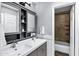 Bathroom with double sinks, a cabinet, and a view of the shower and bathtub at 8936 N 80Th Pl, Scottsdale, AZ 85258