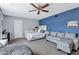 This bedroom features a ceiling fan, a bed, and a couch in an open space at 8936 N 80Th Pl, Scottsdale, AZ 85258