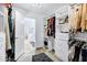 Walk-in closet with custom shelves and drawers leading to the Primary bathroom at 8936 N 80Th Pl, Scottsdale, AZ 85258