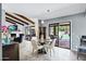 Dining area with views of the backyard pool and patio, open floor plan and exposed beams at 8936 N 80Th Pl, Scottsdale, AZ 85258