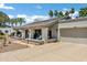 Attractive home with a covered porch, desert landscaping, and a two-car garage at 8936 N 80Th Pl, Scottsdale, AZ 85258