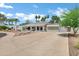 Well-maintained home featuring a spacious driveway and desert landscaping at 8936 N 80Th Pl, Scottsdale, AZ 85258