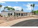 Charming exterior elevation with desert landscaping and palm trees on a sunny day at 8936 N 80Th Pl, Scottsdale, AZ 85258