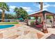Inviting gazebo featuring comfortable seating, overlooking a sparkling pool and lush landscaping for serene outdoor living at 8936 N 80Th Pl, Scottsdale, AZ 85258