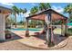 Charming gazebo with lounge chairs overlooking a sparkling pool and lush landscaping for outdoor relaxation at 8936 N 80Th Pl, Scottsdale, AZ 85258