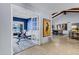 Hallway featuring tiled floors, decorative art, and an office space with French doors to the left at 8936 N 80Th Pl, Scottsdale, AZ 85258