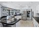 White kitchen features black countertops, stainless steel appliances, and tile floors at 8936 N 80Th Pl, Scottsdale, AZ 85258
