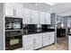 Bright kitchen features white cabinets and black countertops with built in oven at 8936 N 80Th Pl, Scottsdale, AZ 85258